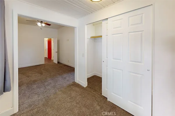 a view of a big room with windows and closet