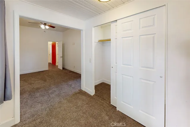 a view of a big room with windows and closet