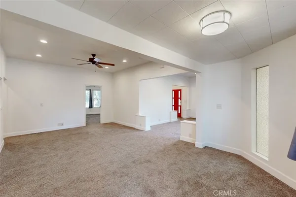 an empty room with a empty space and windows