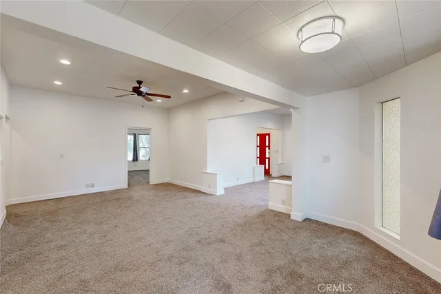 an empty room with a empty space and windows