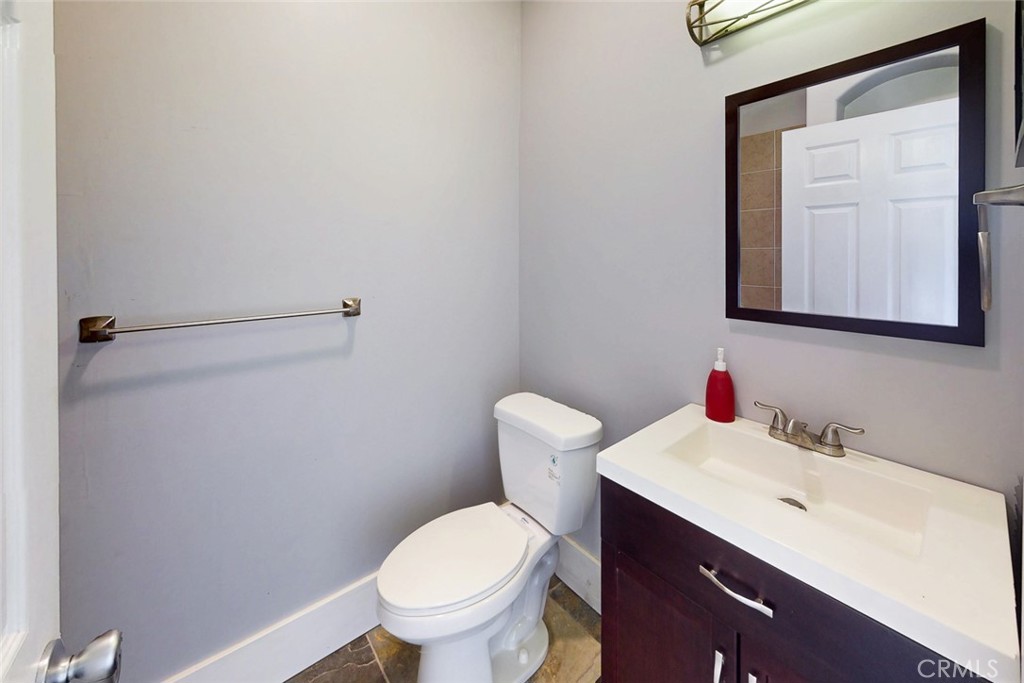 1585 Sycamore Street Gridley, CA 95948 - Photo 31 of 66 a bathroom with a toilet sink and mirror