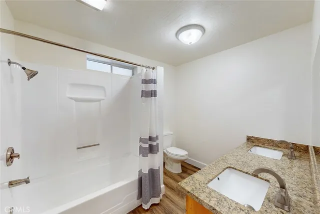 a front view of a house with a garden and trees