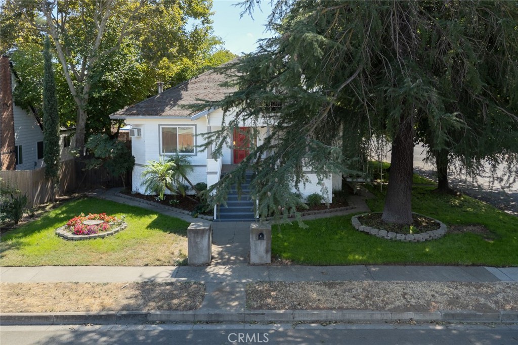 1585 Sycamore Street Gridley, CA 95948 - Photo 45 of 66 a front view of a house with a garden and trees
