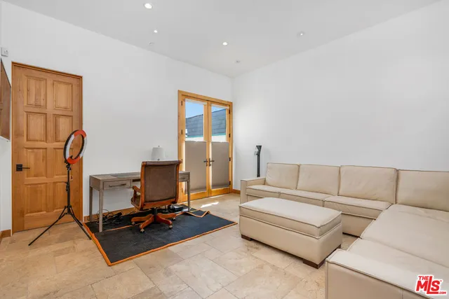 a view of a hallway with wooden floor and a refrigerator