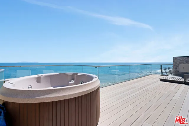 a bedroom with a bed and large window