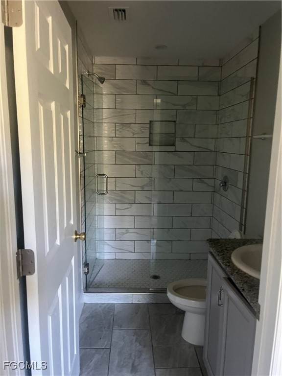 154 Village Circle LaBelle, FL 33935 - Photo 5 of 6 a bathroom with a granite countertop toilet a sink and shower