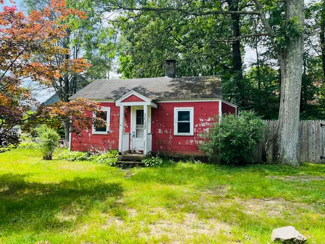 a front view of a house with a yard table and chairs