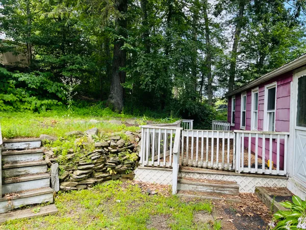 a view of a room with wooden floor and window