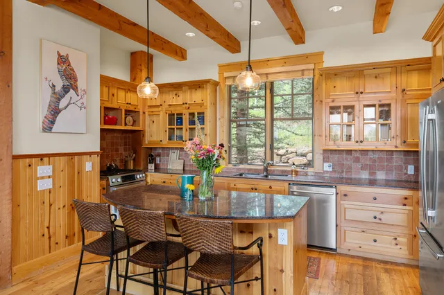 a dining table with chairs and window