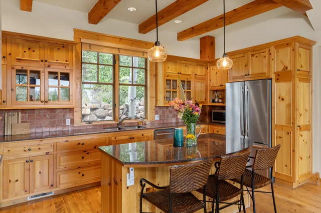 a dining table with chairs and chandelier