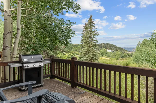 a balcony with wooden floor and fence