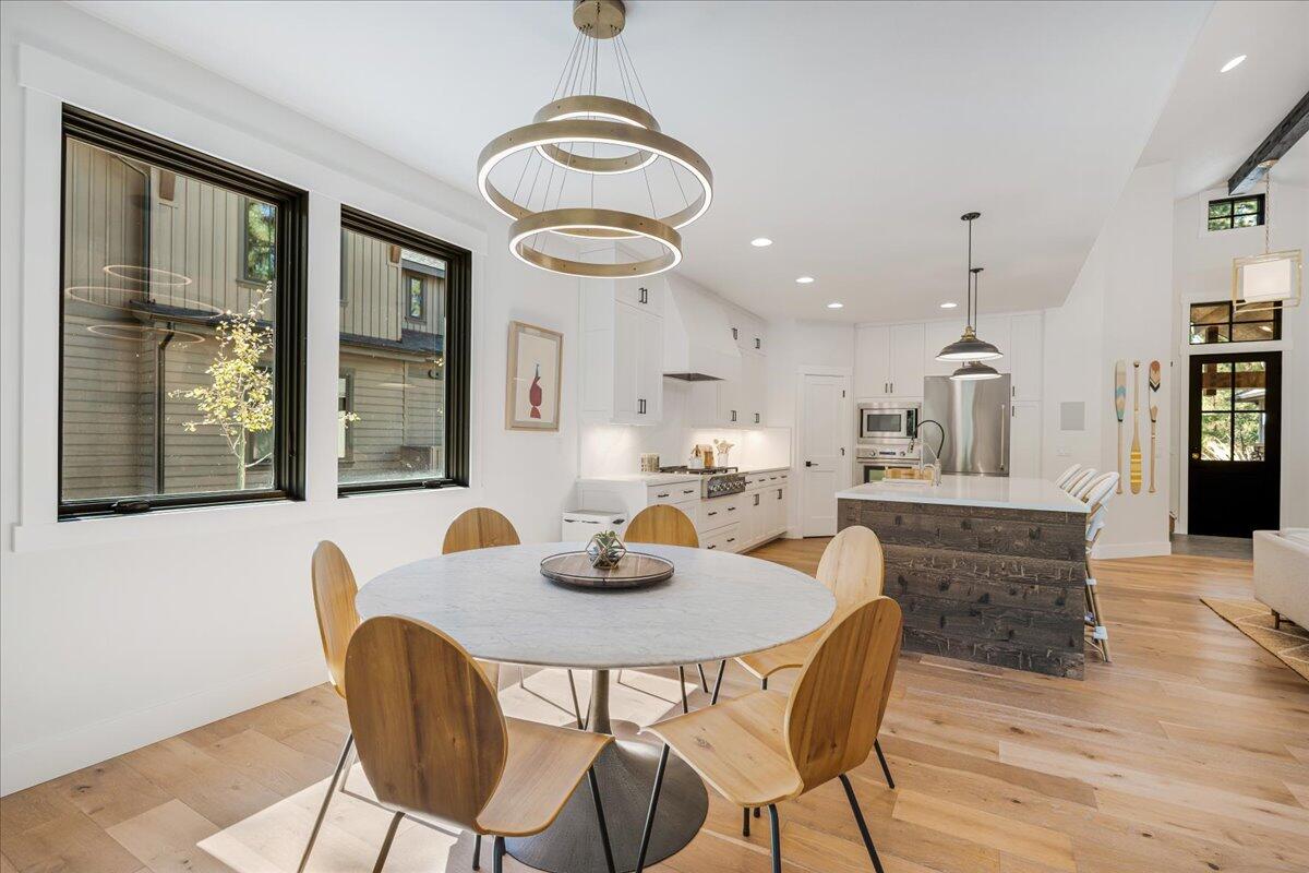 56278 Sable Rock Loop Bend, OR 97707 - Photo 18 of 54 a dining room with wooden floor and a chandelier