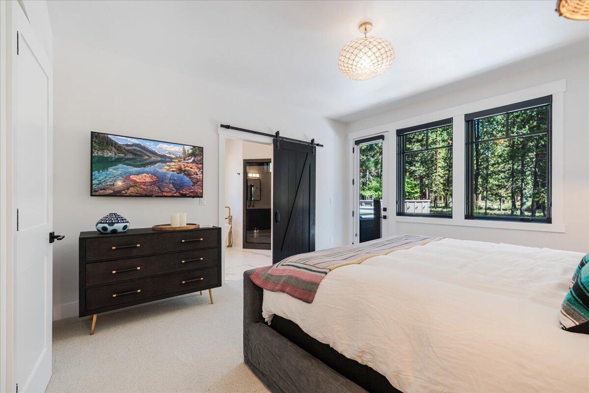 56278 Sable Rock Loop Bend, OR 97707 - Photo 19 of 54 a bedroom with a bed and a painting on the wall