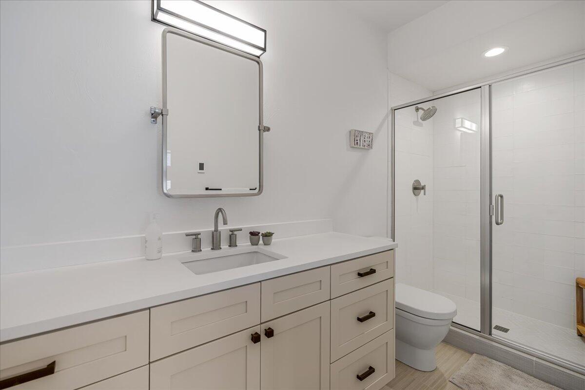 56278 Sable Rock Loop Bend, OR 97707 - Photo 26 of 54 a bathroom with a sink a toilet and shower