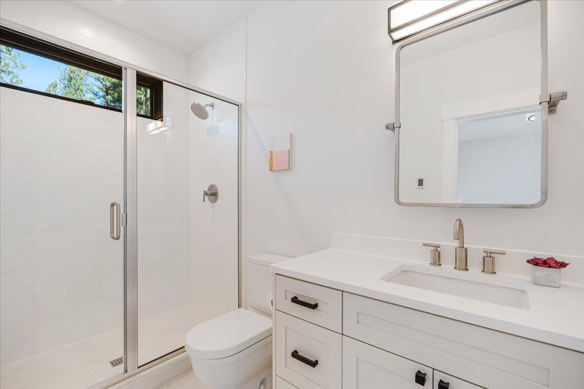 56278 Sable Rock Loop Bend, OR 97707 - Photo 29 of 54 a bathroom with a sink a toilet and shower