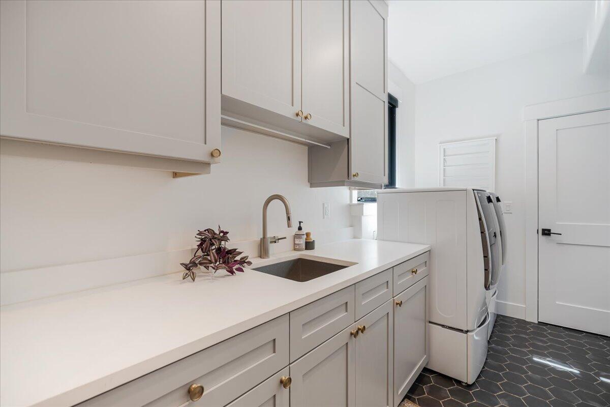 56278 Sable Rock Loop Bend, OR 97707 - Photo 31 of 54 a kitchen with stainless steel appliances a sink a refrigerator and cabinets
