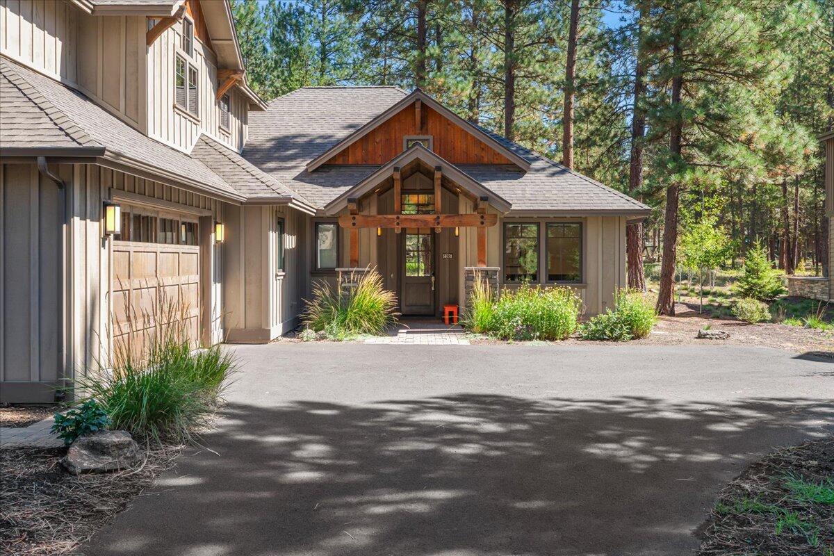56278 Sable Rock Loop Bend, OR 97707 - Photo 3 of 54 a front view of a house with a yard and glass windows