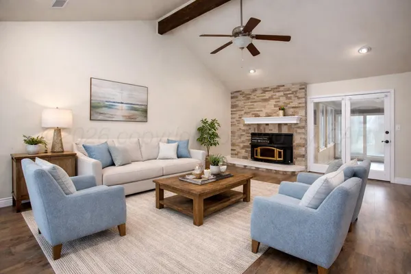 a living room with furniture a fireplace and a ceiling fan