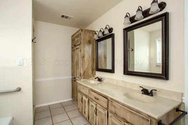 an empty room with fan and windows