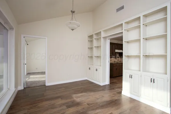 a view of wooden floor and windows in a room
