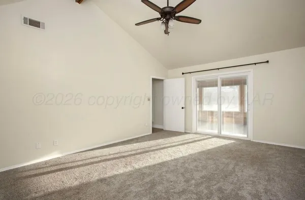 a view of a livingroom with a ceiling fan and window