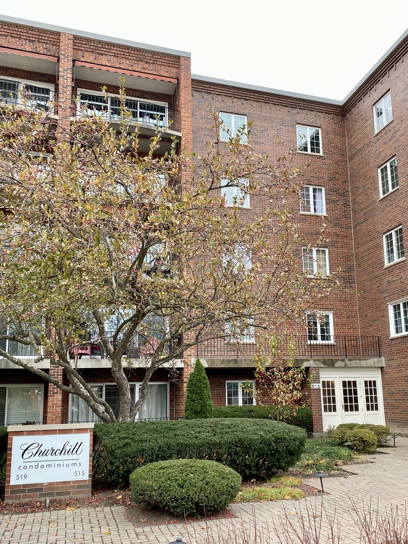 515 North Main Street, Unit 4AS Glen Ellyn, IL 60137 - Photo 23 of 23 a front view of a building with garden