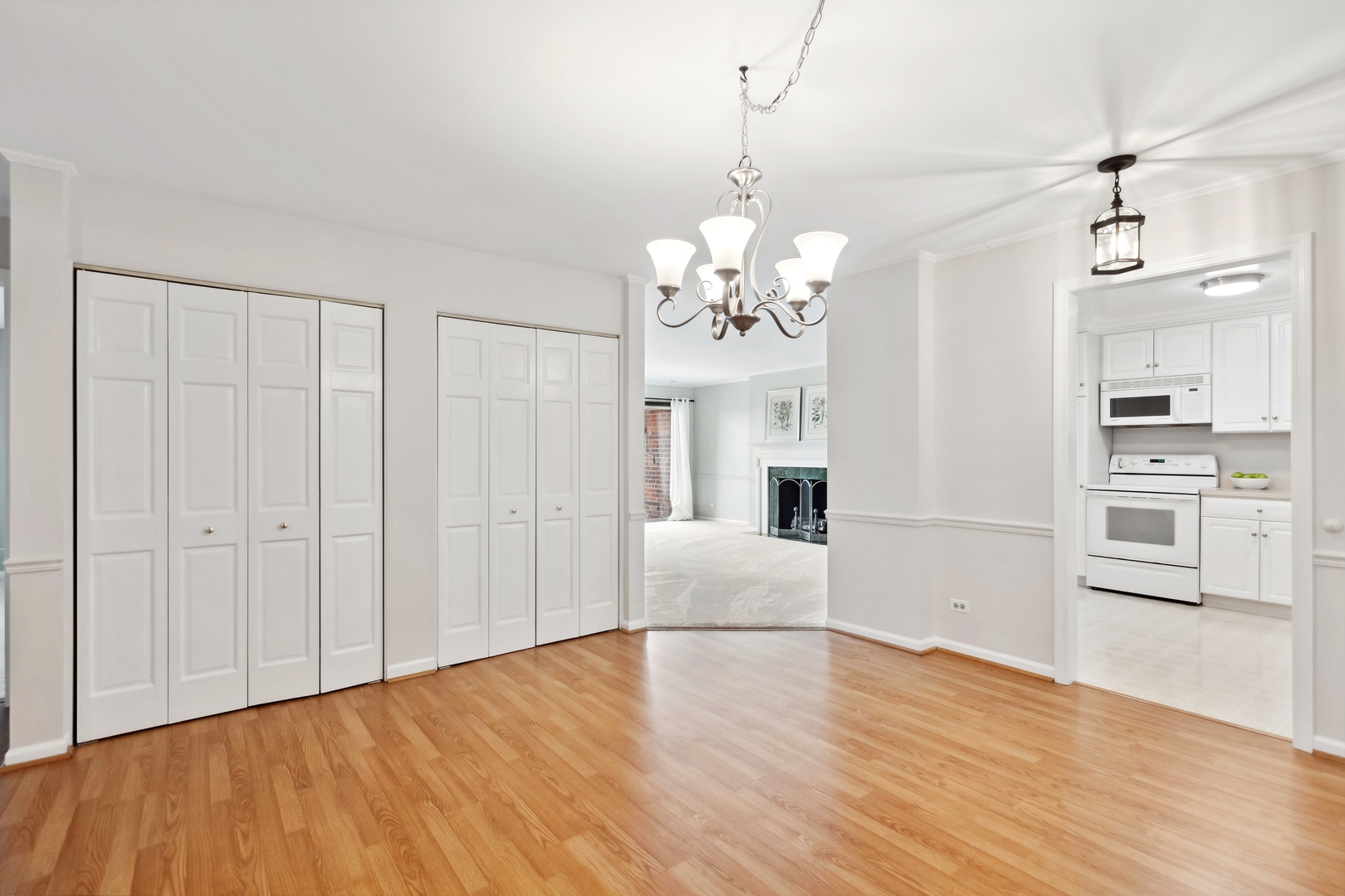 515 North Main Street, Unit 4AS Glen Ellyn, IL 60137 - Photo 5 of 23 a view of a livingroom with a furniture wooden floor kitchen chandelier and entryway