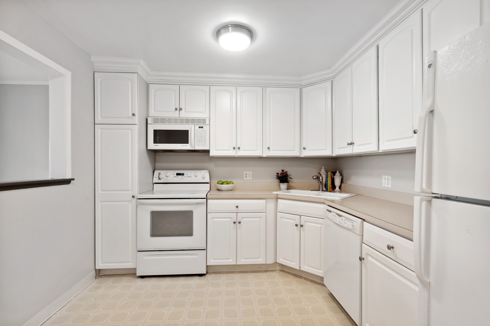 515 North Main Street, Unit 4AS Glen Ellyn, IL 60137 - Photo 9 of 23 a kitchen with white cabinets and white appliances