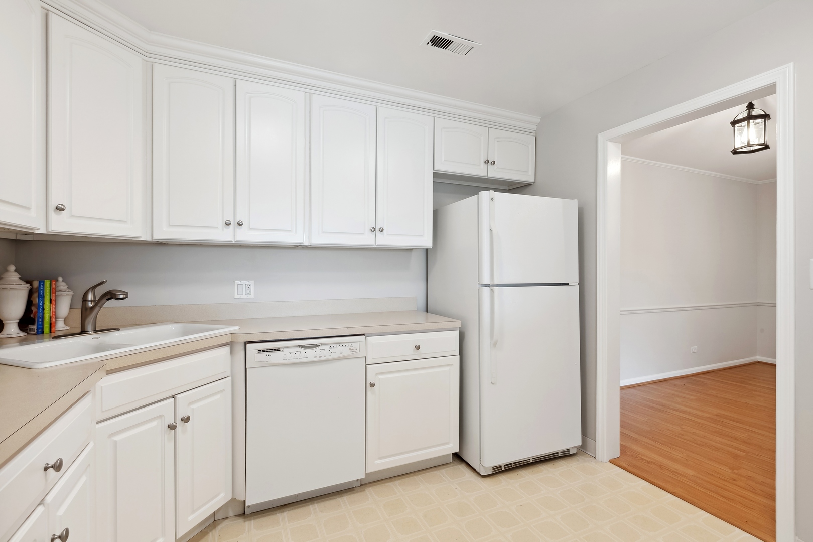 515 North Main Street, Unit 4AS Glen Ellyn, IL 60137 - Photo 10 of 23 a white refrigerator freezer sitting in a kitchen