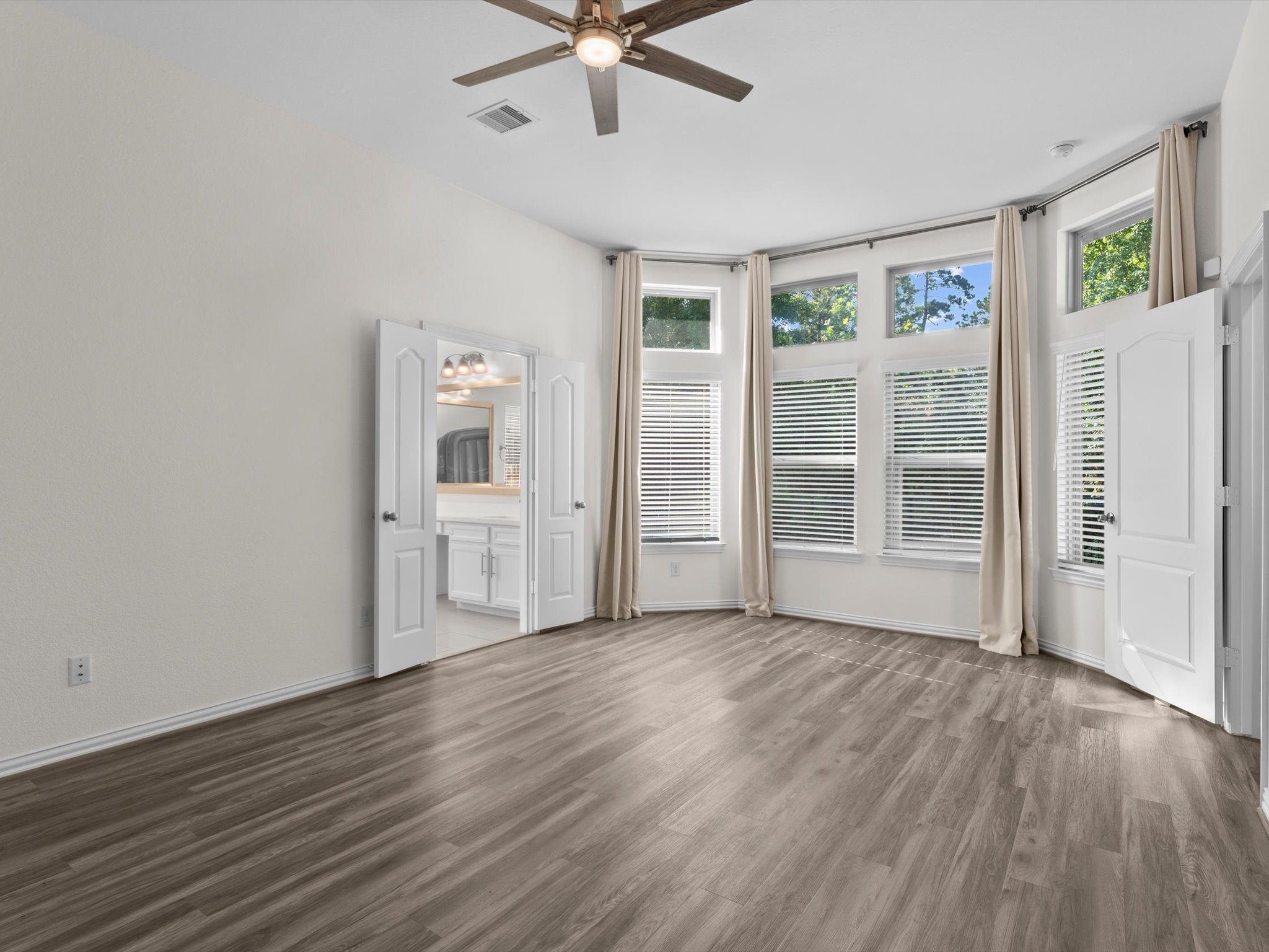 4746 Misty Ranch Drive Spring, TX 77386 - Photo 27 of 49 Oversized primary bedroom with large picture windows that bring in abundant natural light and create a bright, inviting retreat.