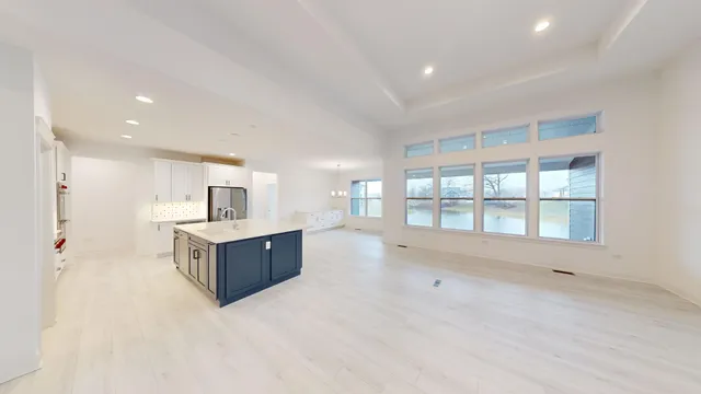 a large room with a large window and furniture