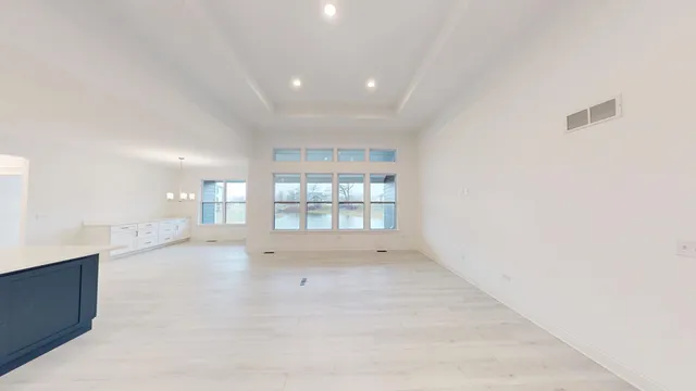 an empty room with a fireplace and windows
