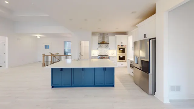 a kitchen with a refrigerator and a sink