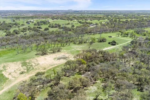 a view of outdoor space with green field and trees