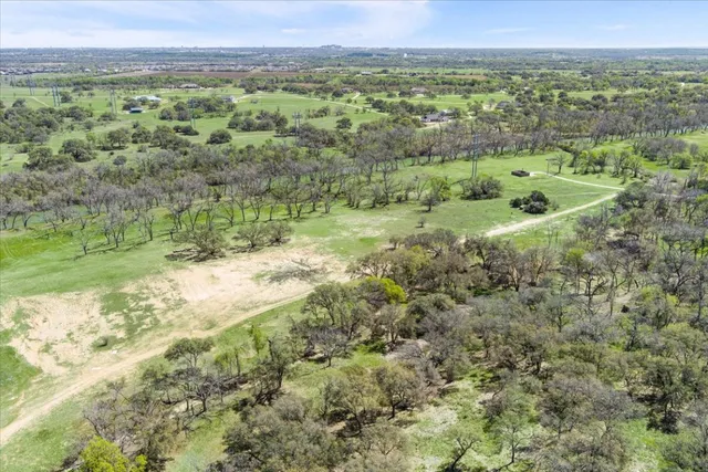 a view of outdoor space with green field and trees