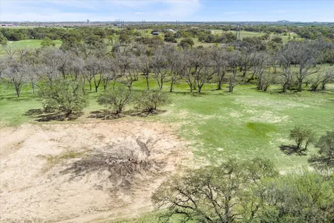 a view of field with trees in the background