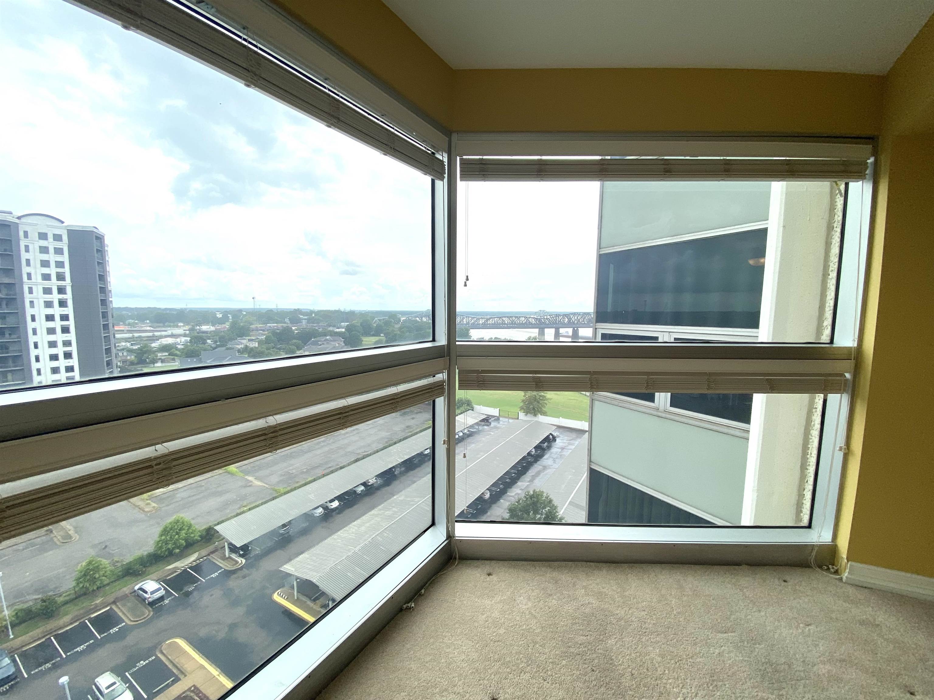 655 Riverside Drive, Unit 1104B Memphis, TN 38103 - Photo 10 of 20 a view of a room with wooden floor and a large window