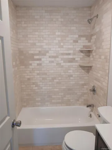 a bathroom with a bathtub and a toilet