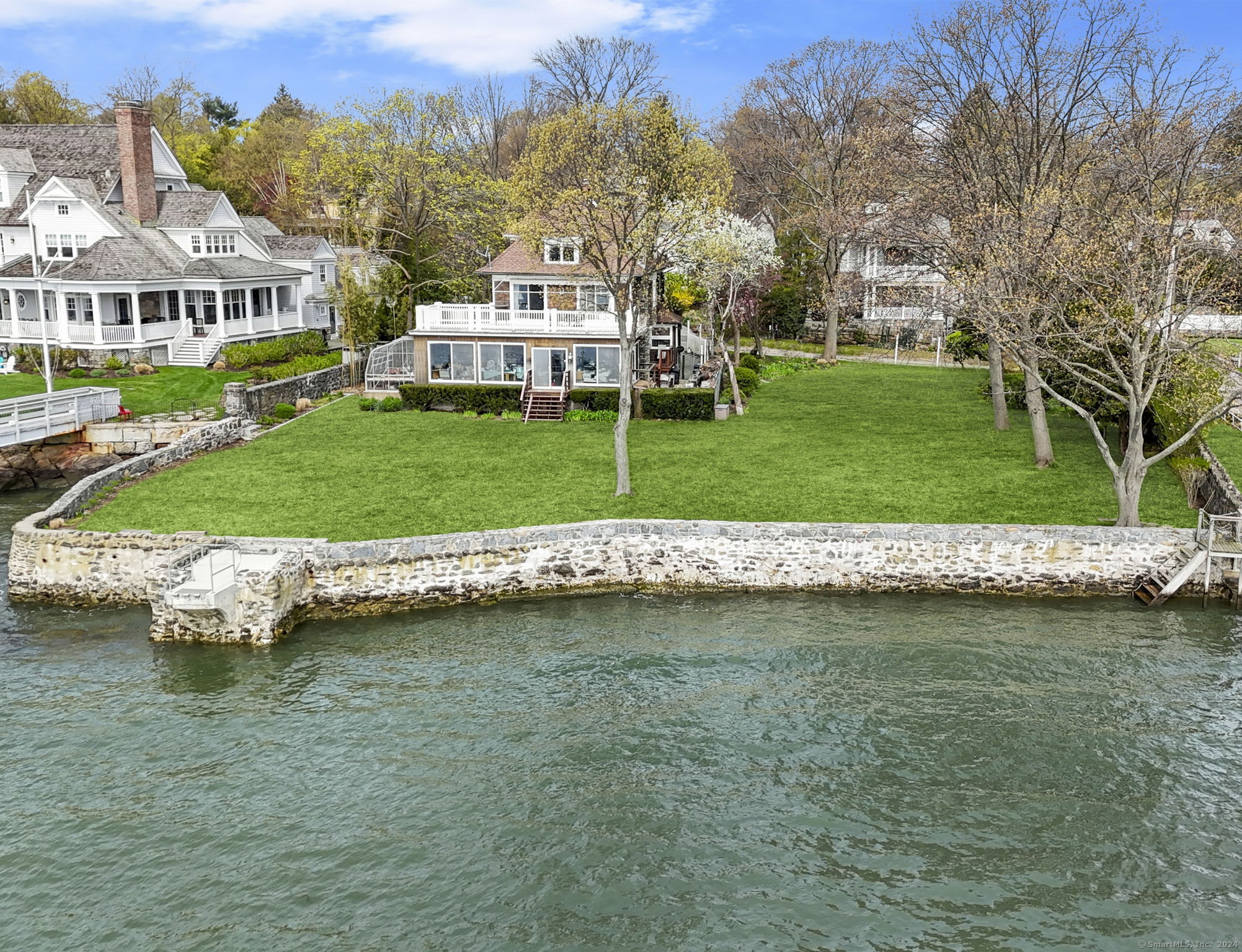 33 Byram Shore Road Greenwich, CT 06830 - Photo 1 of 1 a view of a house with a yard and a large pool
