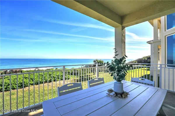 a view of a chairs and table in patio with wooden floor