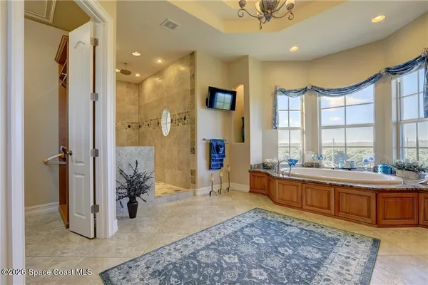 a large spacious bathroom with a tub and shower