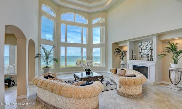 a living room with furniture fireplace and a large window