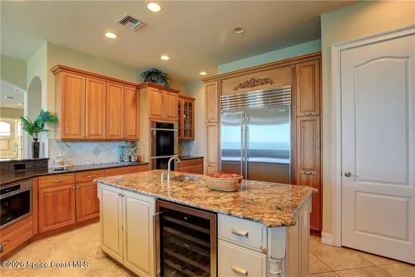 a kitchen with granite countertop sink and cabinets