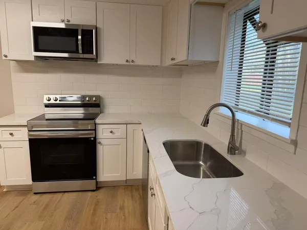 a kitchen with a stove and a microwave