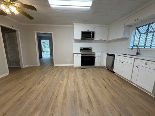 a kitchen with stainless steel appliances a sink dishwasher stove refrigerator and microwave