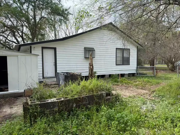 a front view of house with a garden
