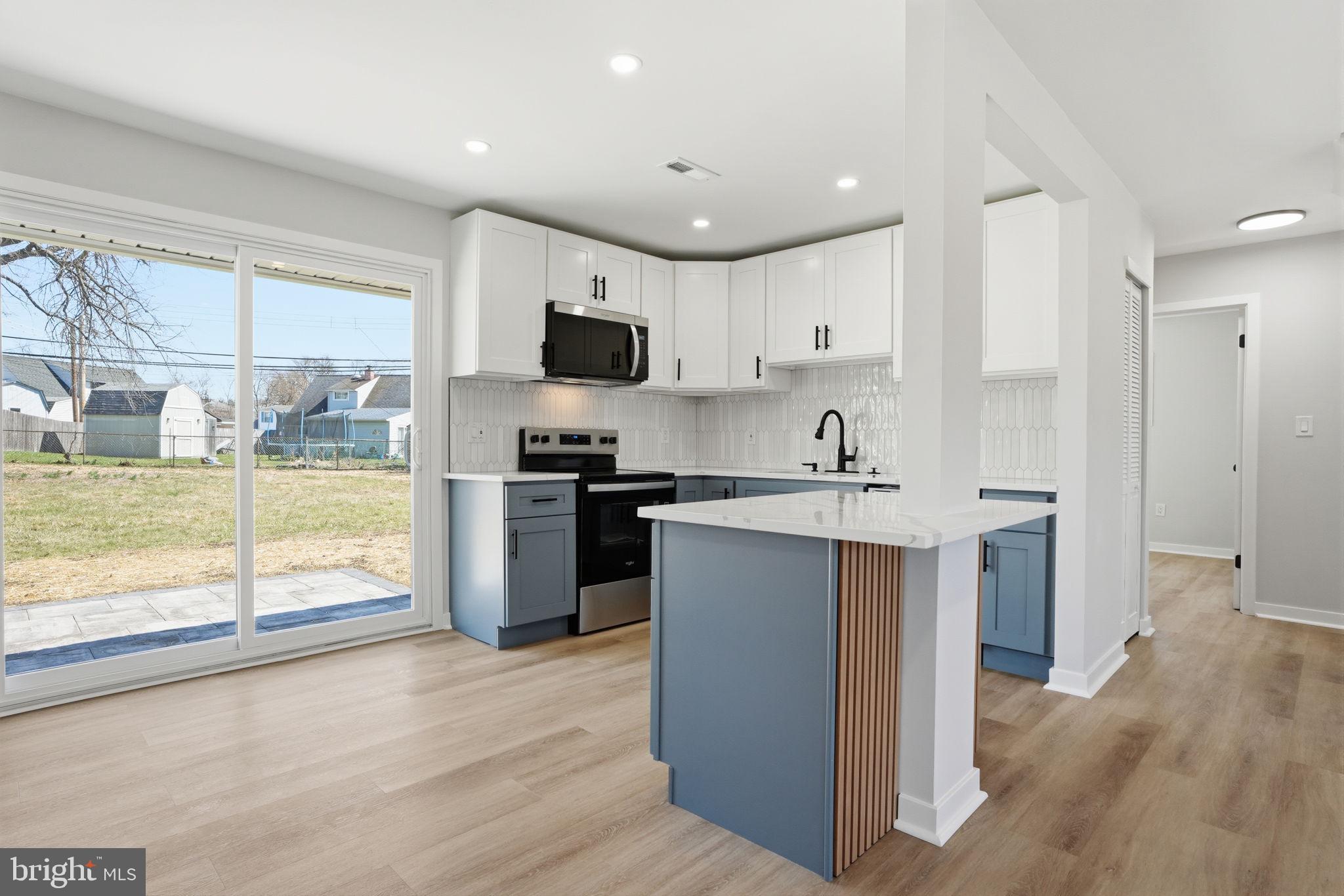 10 MacIntosh Road Levittown, PA 19056 - Photo 13 of 41 a kitchen with kitchen island a sink appliances and cabinets