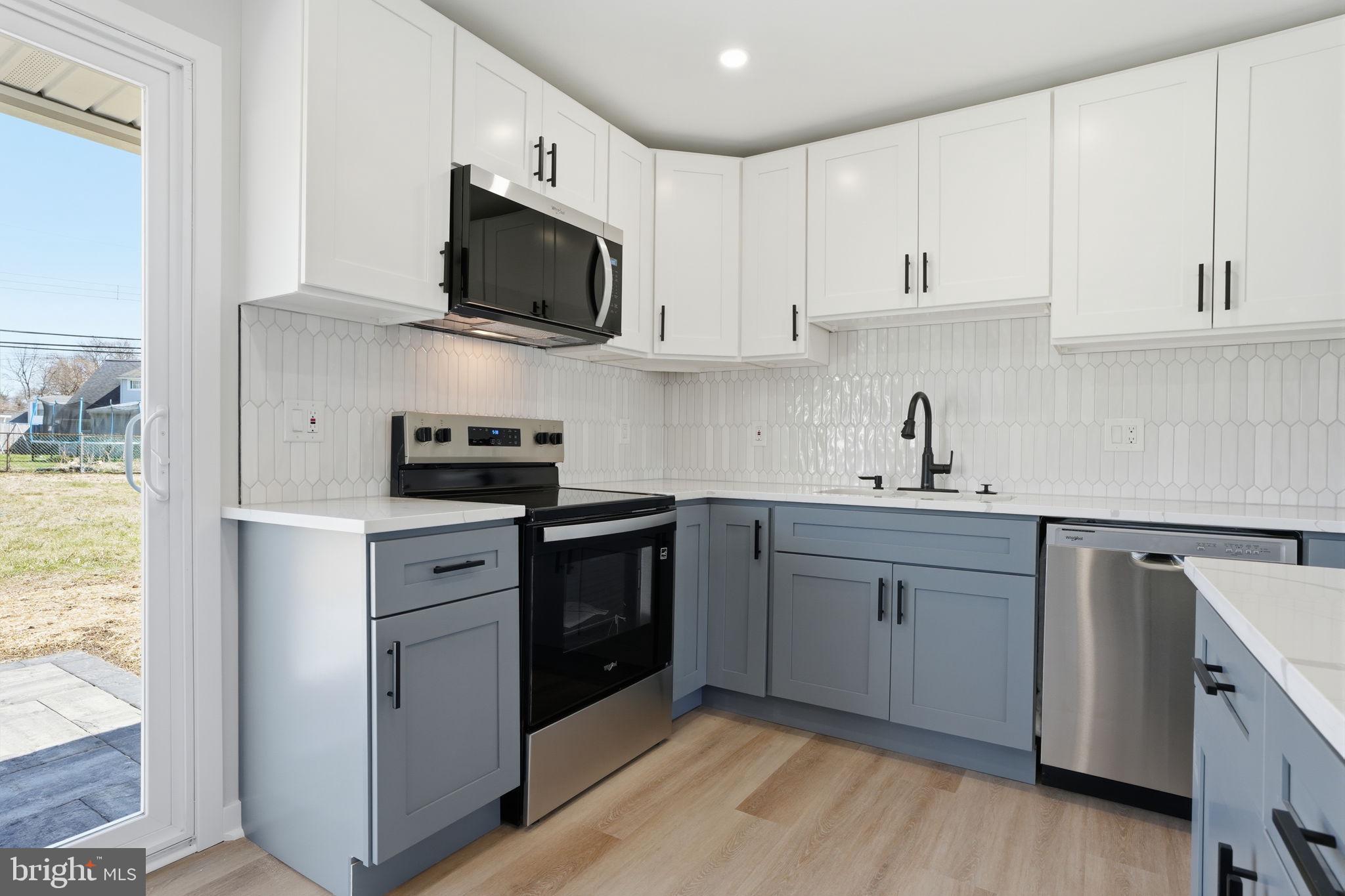 10 MacIntosh Road Levittown, PA 19056 - Photo 14 of 41 a kitchen with cabinets stainless steel appliances and sink