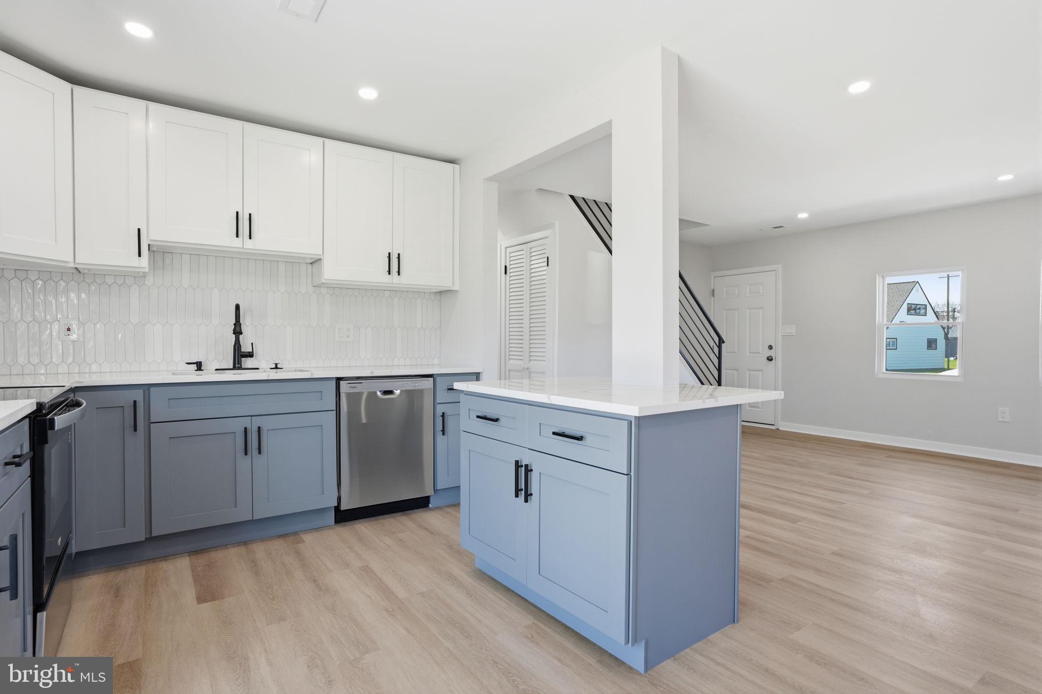 10 MacIntosh Road Levittown, PA 19056 - Photo 15 of 41 a kitchen with cabinets wooden floor and a sink