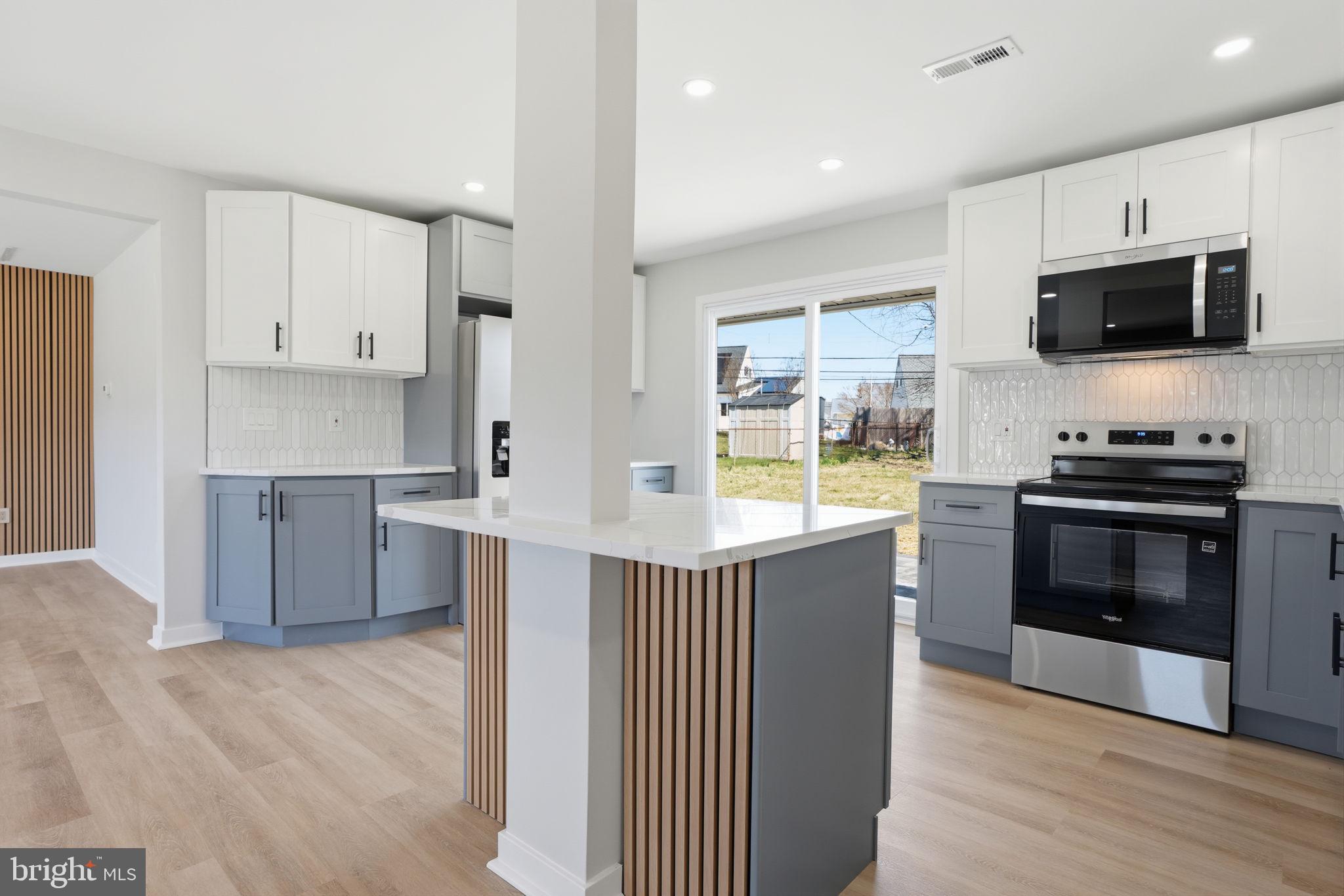 10 MacIntosh Road Levittown, PA 19056 - Photo 17 of 41 a kitchen with stainless steel appliances a stove a sink and a microwave